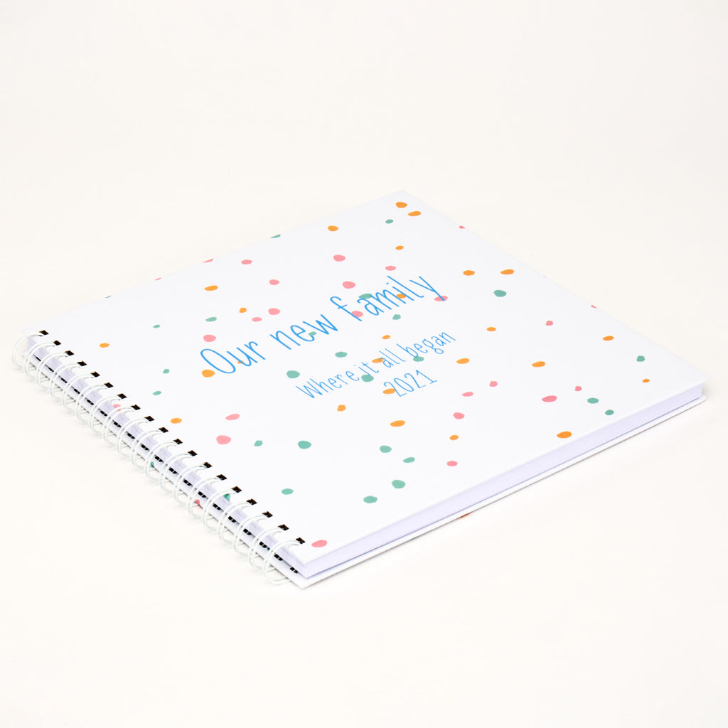 Ring-bound Memory Book that can be personalised, for example, Our new family, where it all began. In blue text
