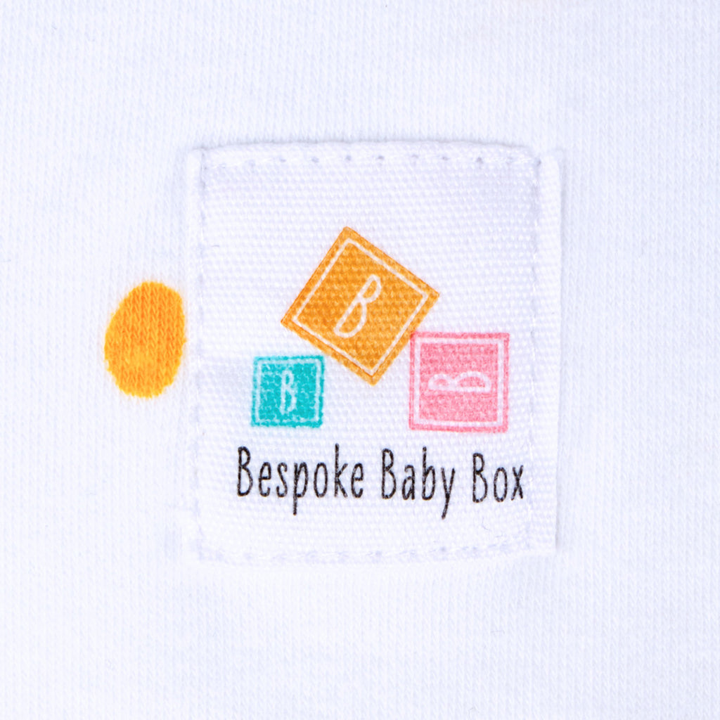 Close up of the Bespoke Baby Box logo label on a baby Blanket in neutral pastel colours