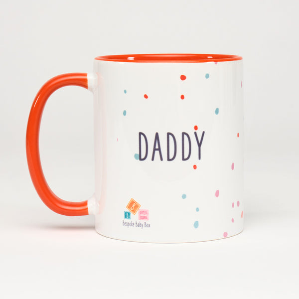 Mug with the word "Daddy" with a small Bespoke Baby Box logo, a neutral dotty pattern design and  orange handle and inside 