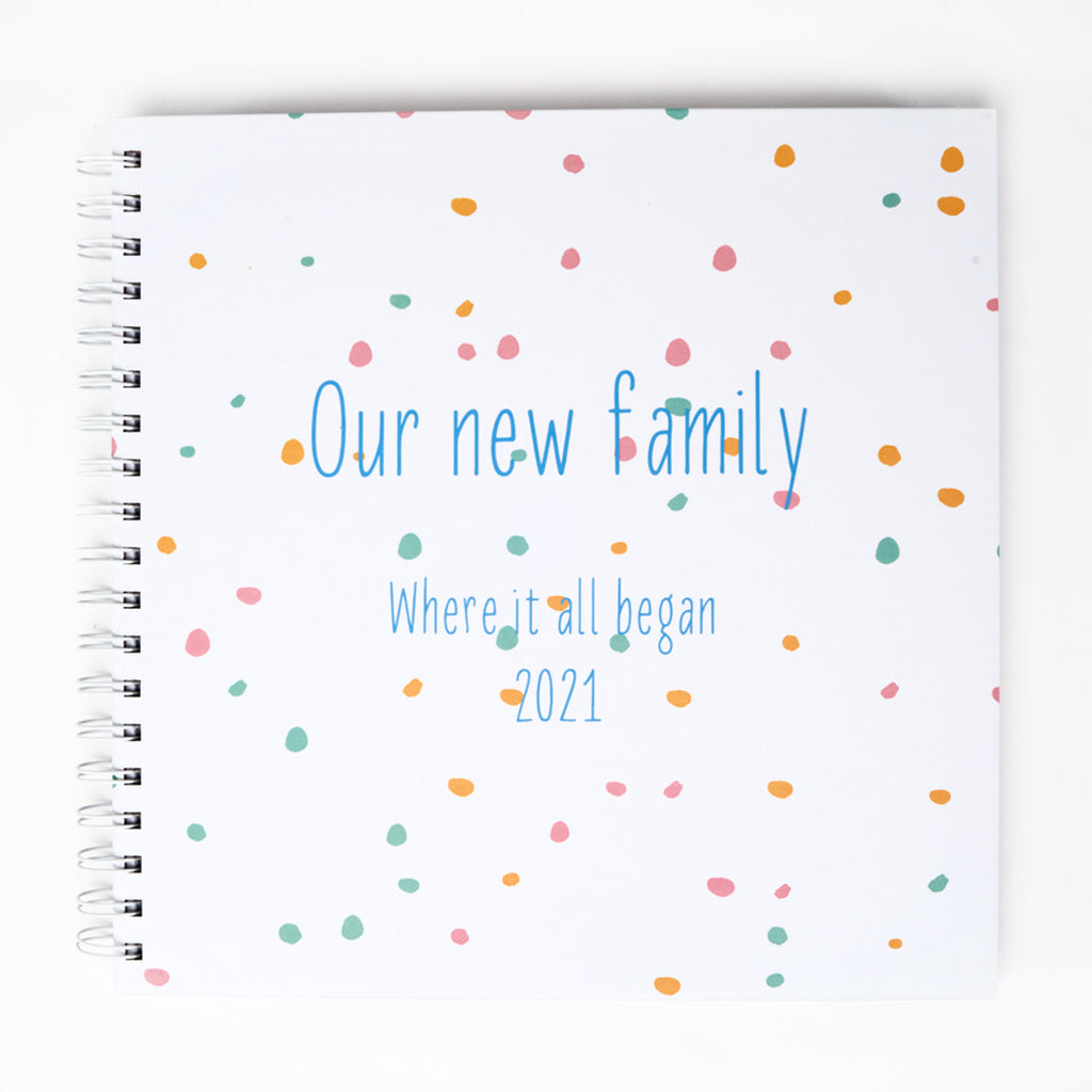 Ring-bound Memory Book that can be personalised, for example, Our new family, where it all began. In blue text 