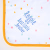 Close up of the words "Reggie, Best little Brother" embroidered in blue thread on a Personalised baby Blanket in neutral pastel colours with an orange trim.