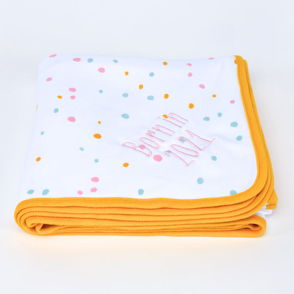 Personalised embroidered baby Blanket in neutral pastel coloured dotty pattern with a striking orange trim