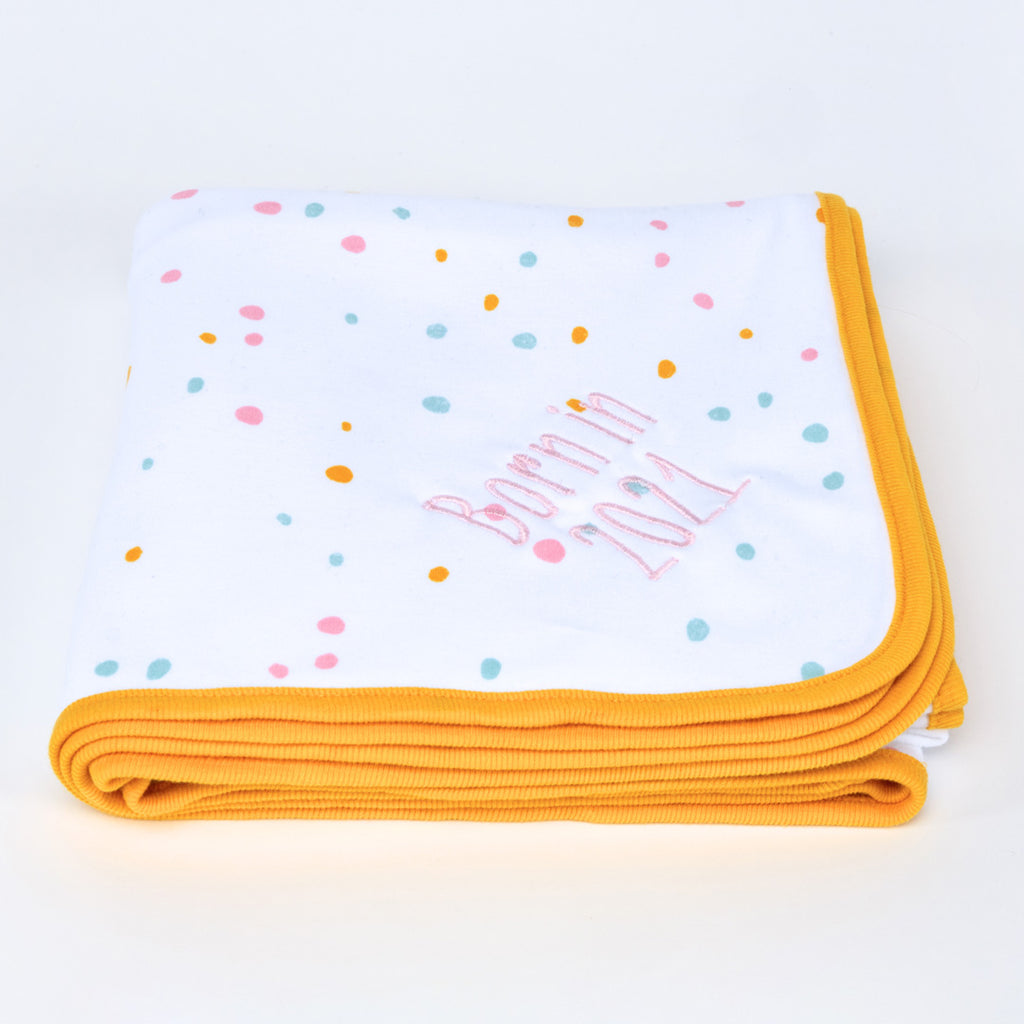 Personalised embroidered Blanket in neutral pastel coloured dotty pattern with a striking orange trim